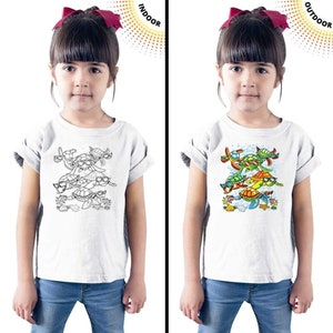 May include: A white t-shirt with a design of multiple turtles wearing sunglasses. The design is black and white when viewed indoors and appears in color when viewed outdoors. The words "INDOOR" and "OUTDOOR" are printed on the image.