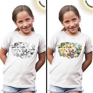 May include: A white t-shirt with a color-changing design. The design shows two unicorns in a field of flowers. The design is black and white indoors and colorful outdoors.
