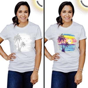 May include: A white t-shirt with a colorful palm tree design that changes color when exposed to UV light. The design features a sunset, palm trees, and ocean waves. The words "INDOOR" and "OUTDOOR" are visible in the image.