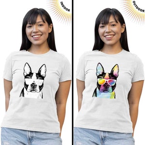May include: White t-shirts featuring a Boston Terrier dog wearing sunglasses. One shirt has a black and white graphic, the other a colorful watercolor design. The shirts are displayed indoors and outdoors.