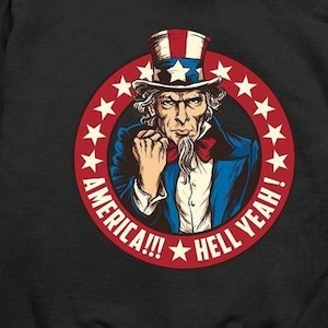 May include: Black hooded sweatshirt with a small American flag on the left chest and a graphic of Uncle Sam on the back with the text "America!!! Hell Yeah!"