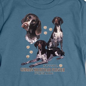 May include: A blue t-shirt with a graphic of a German Shorthaired Pointer dog. The text on the shirt reads "If it's not a German Shorthaired Pointer it's just a dog."