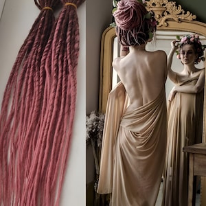 May include: Two sets of long, pink and brown synthetic dreadlocks. The dreadlocks are hanging straight down and are about 2 feet long.