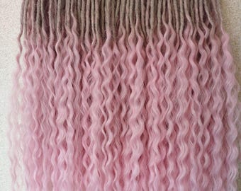 May include: A set of synthetic hair extensions featuring a two-tone ombre design. The upper section consists of straight, light brown dreadlocks that transition into long, wavy, light pink strands hanging from a red wire clothes hanger.