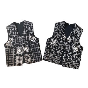 May include: Two black sleeveless vests with a white geometric pattern. The vests have a V-neck and are made of a soft, comfortable fabric.