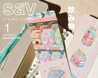 May include: Holographic bookmarks featuring illustrations of milk cartons with Japanese text, including "ミルク" (milk) and "新発売" (new release). The bookmarks are pink, blue and white with a glittery finish.
