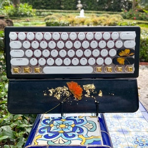 Bluetooth Black Gold and Orange flower keyboard and wrist rest set.