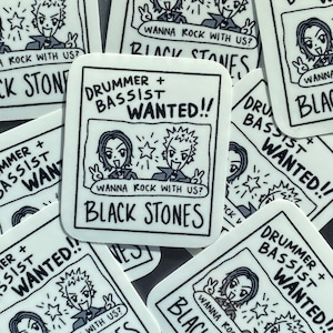 May include: A collection of white stickers with a black and white manga-style illustration. The stickers feature the text "Drummer + Bassist Wanted!!" and "Wanna Rock With Us?" along with the band name "Black Stones".