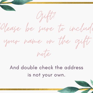 May include: A white card with a gold border and green leafy vines on the top and bottom. The text on the card reads "Gift? Please be sure to include your name on the gift note. And double check the address is not your own."