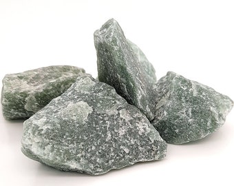 May include: Four rough, green, natural stone crystals on a white background.