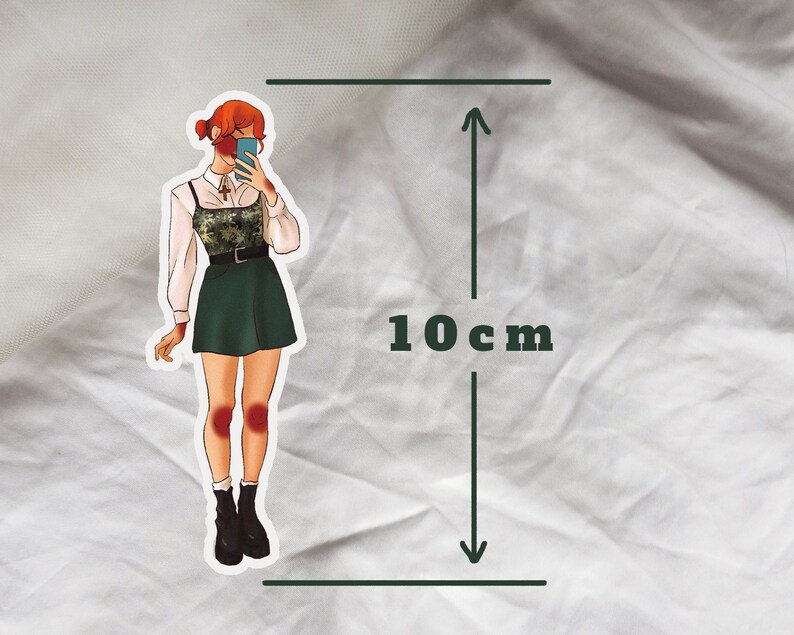 May include: A sticker of a woman with red hair wearing a green skirt and a white shirt with a camouflage pattern. She is holding a phone up to her face and smiling. The sticker is 10 cm tall.