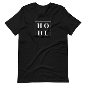 May include: Black t-shirt with a white square containing the text "HODL" in all caps.