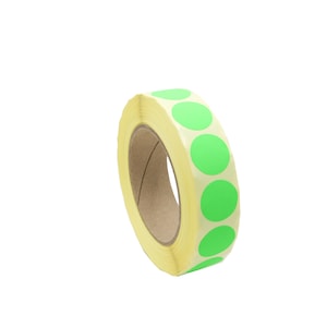 May include: A roll of green round stickers on a yellow backing. The stickers are arranged in a circle around the roll.