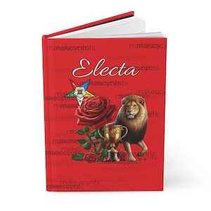 May include: Red hardcover journal with the word "Electa" in gold lettering. The cover features a red rose, a golden trophy, and a lion with a Masonic symbol.