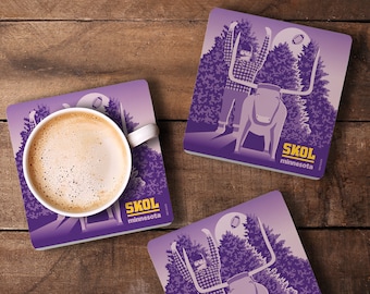 May include: Square purple coasters with a graphic of a person with arms raised, a longhorn, and a football, with the text "SKOL minnesota". One coaster holds a white coffee cup with a brown beverage.