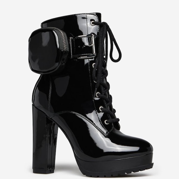 Pair of sexy high heel shoes, with built-in practical pouch. Comfortable to wear. Boots in imitation black leather.