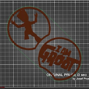 May include: Two brown 3D printed shapes, one with a silhouette of a character from the movie Guardians of the Galaxy, and the other with the text "I am Groot".