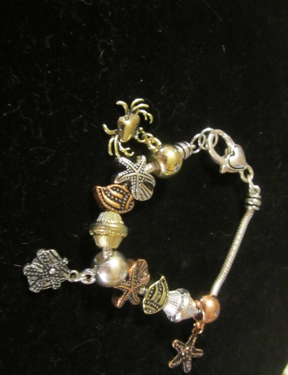 Silver  Bronze and gold toned charm bracelet
