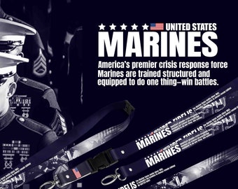 May include: Navy blue lanyard featuring the text "MARINES" and "SEMPER FIDELIS" with the American flag. The lanyard has a black plastic buckle and a metal clasp. The background includes a photo of Marines.