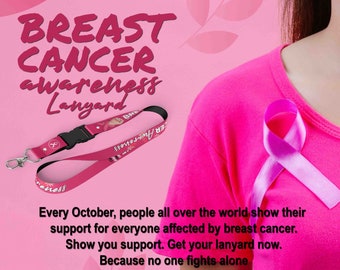 May include: Pink breast cancer awareness lanyard with a black clip and the text "Breast Cancer Awareness" printed on it. The lanyard is on a pink background with a pink ribbon and a woman wearing a pink shirt.