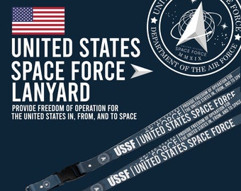 May include: A blue lanyard with the text "USSF | UNITED STATES SPACE FORCE" printed on it. The lanyard features a small silver rocket ship charm. The text "PROVIDE FREEDOM OF OPERATION FOR THE UNITED STATES IN, FROM, AND TO SPACE" is printed on the lanyard. The text "CUSTOM DESIGNED BY PRINTMAGIC" is printed at the bottom of the image.