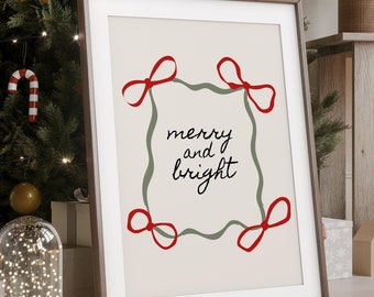May include: A framed print with a white background and a green and red design. The print says "merry and bright" in black cursive lettering.