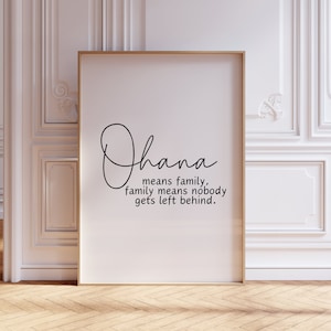 May include: A white framed print with the word "Ohana" written in cursive script. The text below reads "means family, family means nobody gets left behind."
