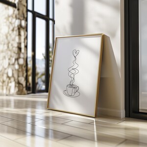 May include: A framed black and white line drawing of a coffee cup with a heart-shaped steam rising from it.