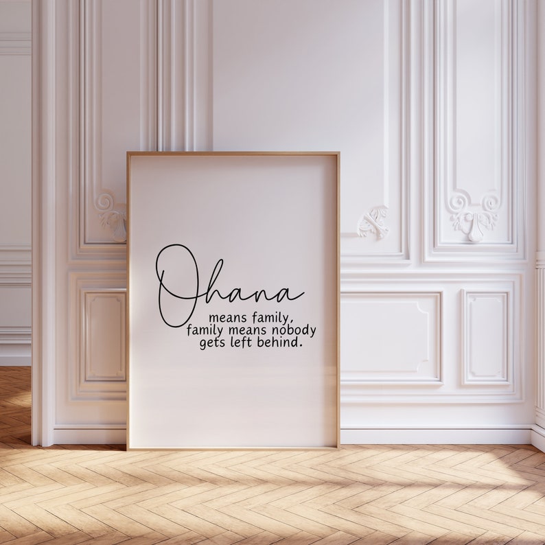May include: A white framed print with the word "Ohana" written in cursive script. The text below reads "means family, family means nobody gets left behind."