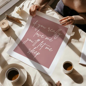 May include: A pink and white printable wall art print with the text "if you really love me you'll let me sleep".