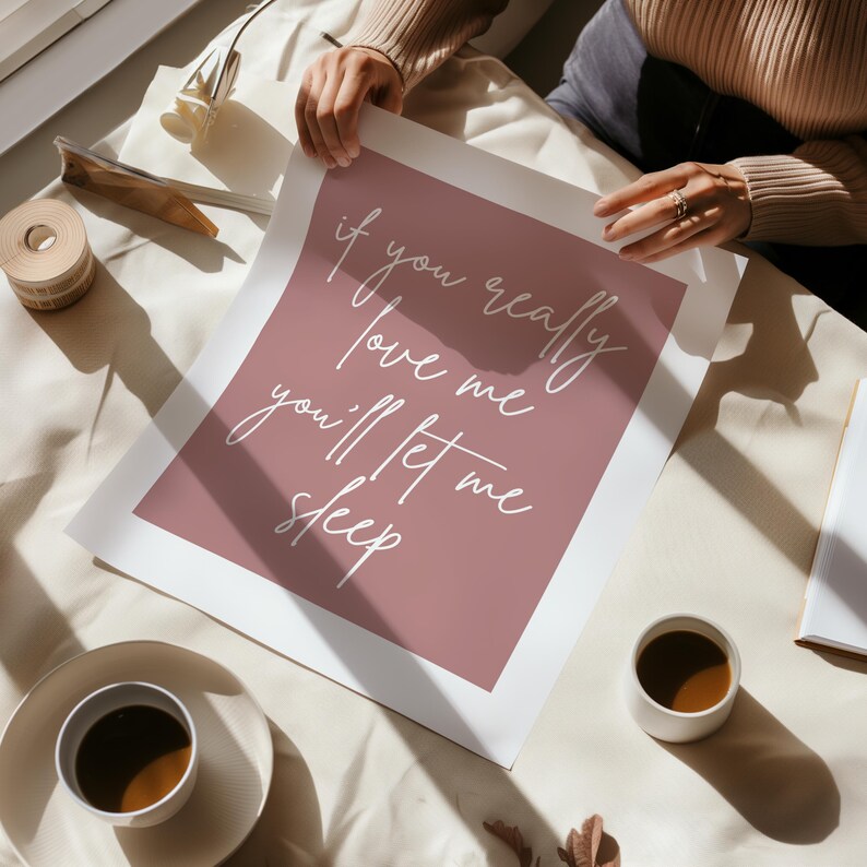 May include: A pink and white printable wall art print with the text "if you really love me you'll let me sleep".
