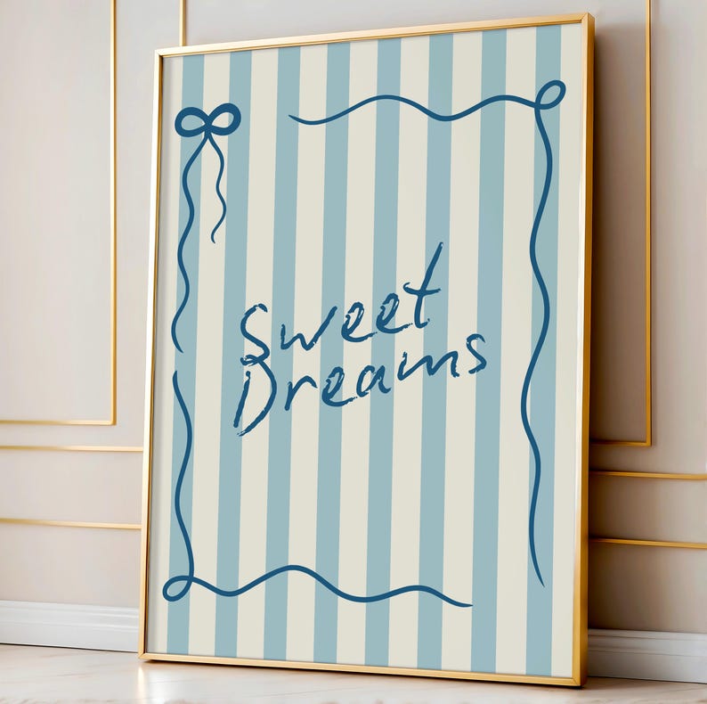 May include: A framed print with a blue and white striped background. The print features a blue cursive script that says "Sweet Dreams" within a blue decorative frame.