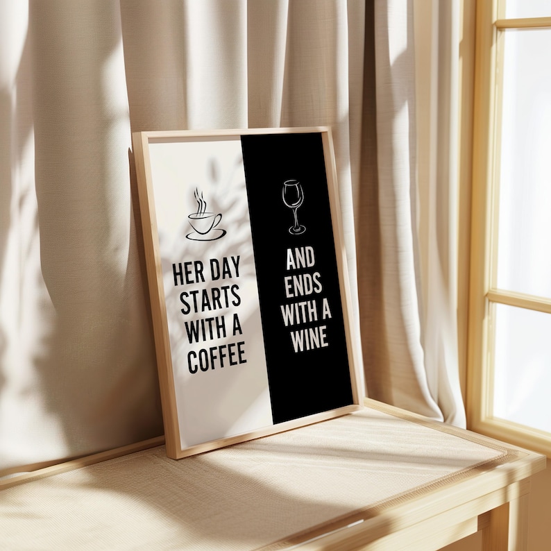 May include: A framed print with a black and white design. The left side is white with a coffee cup and the text "Her day starts with a coffee". The right side is black with a wine glass and the text "And ends with a wine".