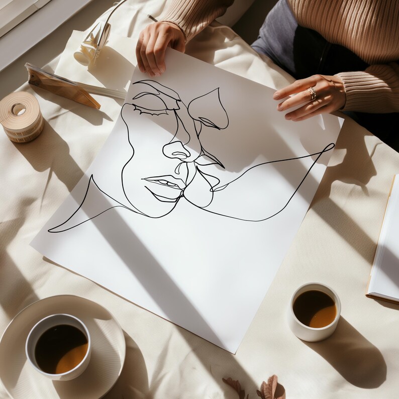 May include: A black and white line drawing of two faces, one on top of the other, with their noses touching. The drawing is on a white sheet of paper.