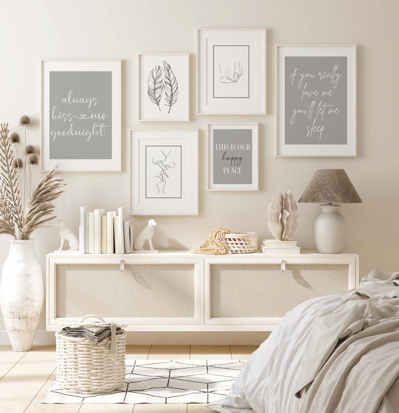 May include: A set of five framed prints with minimalist line art and text. The prints feature phrases like "always kiss me goodnight" and "this is our happy place". The prints are hung on a white wall above a white dresser with a wicker basket and a lamp.