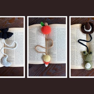May include: Three handmade crochet bookmarks. One features a black bat and gray crescent moon. Another has a red apple and a yellow and white pear. The third has a brown cowboy hat and a green frog.