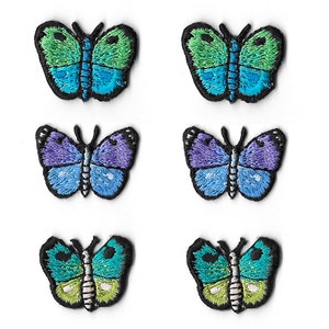 May include: Six embroidered butterfly patches arranged in two columns. The top pair features green and blue wings, the middle pair displays purple and blue wings, and the bottom pair shows teal and lime green wings, all with black borders.