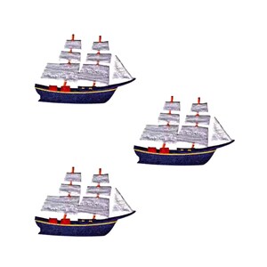 May include: Three identical embroidered ship patches featuring a dark blue hull with a thin yellow trim line. Each ship has white sails with visible horizontal stitching detail, orange masts, and small red accents on the deck of the vessel.