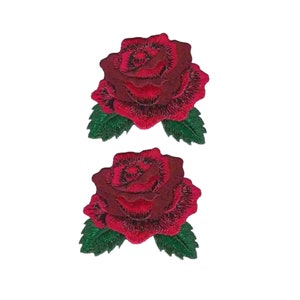 May include: Two identical embroidered rose patches featuring deep red petals with black thread detailing and vibrant green leaves at the base. The floral design is rendered in a dense stitch pattern, creating a textured appearance for each rose.