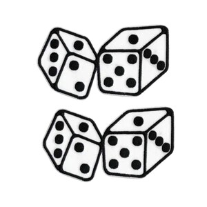 May include: Four white dice patches with black embroidered outlines and black circular pips. Each patch features a three-dimensional perspective of a die showing different numbers of dots on the visible faces, rendered in a clean, high-contrast style.
