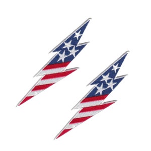 May include: Two iron-on patches featuring a lightning bolt design with the American flag colors of red, white, and blue. The patches are perfect for adding a patriotic touch to clothing, bags, or other items.