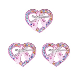 May include: Three pink heart-shaped embellishments with a pair of pink ballet shoes inside each heart. The hearts are decorated with iridescent glitter.