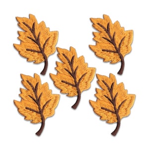 May include: Five embroidered iron-on patches in the shape of autumn leaves. The leaves are a light brown color with a darker brown stem.