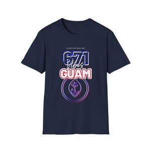 May include: Navy blue t-shirt with the text "671 Vibes Guam" in a stylized design. The design includes a graphic of a palm tree and the text "Island Heir Creations". The shirt is a short-sleeved crew neck.