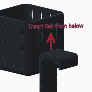 May include: A black, square container with oval cutouts and a separate, rectangular piece. The text "Insert Rail from below" is above a red arrow pointing upwards, indicating assembly instructions. The design appears to be for a storage or organizational product.