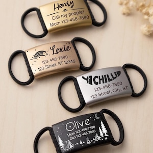 May include: Four personalised pet ID tags with black rubber loops. The tags are gold, silver, and black, each engraved with a name, phone number, and address. One tag says "Henry" and "Call my people!" The other tags say "Lexie", "Chilli", and "Olive".