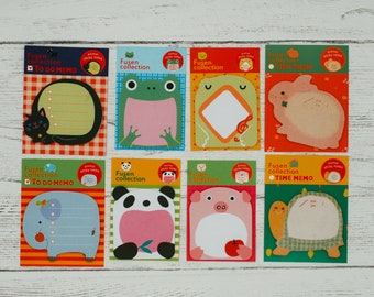 May include: A collection of eight animal-themed sticky note pads. Each pad features a different animal design, including a cat, frog, rabbit, elephant, panda, pig, and turtle. The pads have space for notes and the text "TO DO MEMO" and "TIME MEMO".