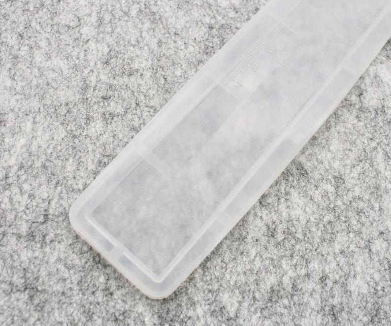 May include: A clear plastic comb with a textured surface. The comb is designed for detangling hair.
