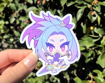 May include: A sticker featuring a cartoon character with purple and blue hair, wearing a mask and holding a star-shaped weapon. The character is surrounded by stars and has a pink and purple gradient.