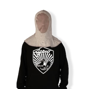 May include: A grey hooded garment with a mesh face opening. The hood is worn over a black sweatshirt with a white rooster graphic and the word "Spero" printed on it.